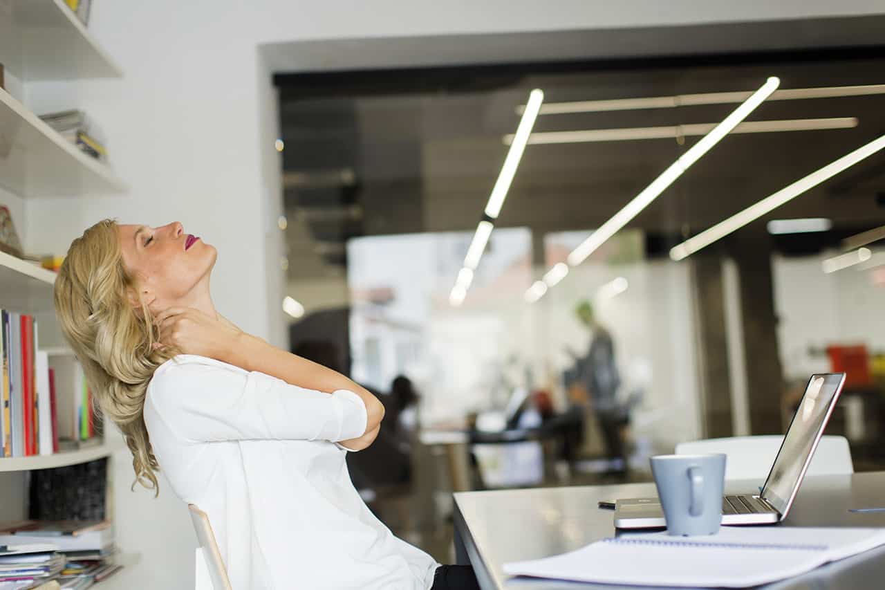 Businesswoman-in-the-office-taking-a-break-and-doing-a-neck-exercise